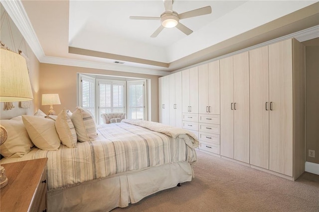 bedroom featuring light carpet, visible vents, a raised ceiling, ceiling fan, and ornamental molding