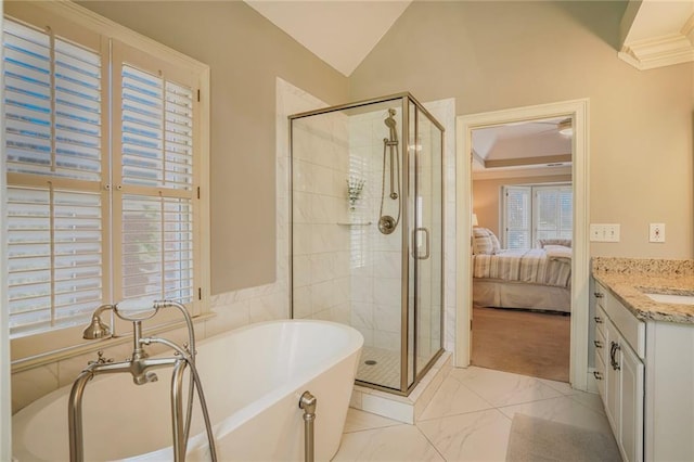 full bath featuring a freestanding bath, vaulted ceiling, a shower stall, vanity, and ensuite bath