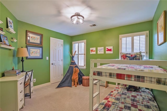 carpeted bedroom with multiple windows, visible vents, and baseboards