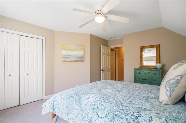 bedroom with visible vents, a ceiling fan, carpet, vaulted ceiling, and a closet