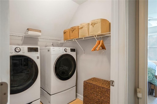 clothes washing area featuring laundry area and washing machine and clothes dryer