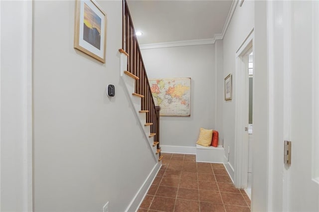 doorway featuring ornamental molding, dark tile patterned flooring, stairway, and baseboards