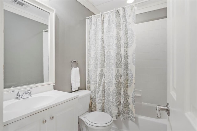 bathroom featuring shower / bath combo, visible vents, vanity, and toilet