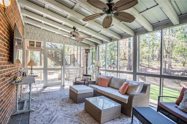 sunroom / solarium featuring vaulted ceiling with beams and a ceiling fan