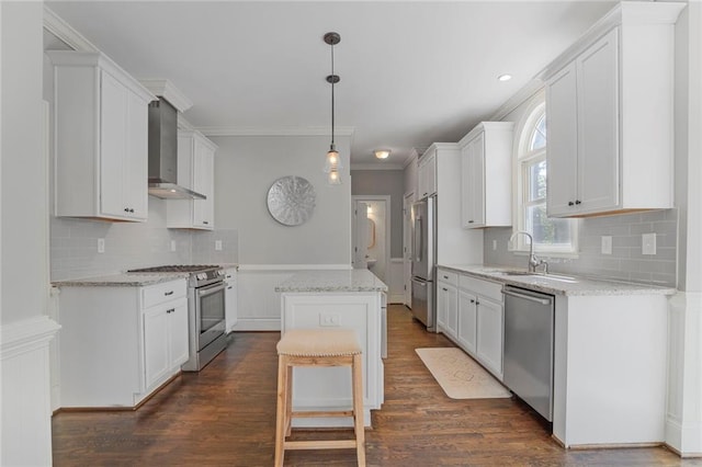 kitchen featuring white cabinets, wall chimney exhaust hood, dark wood-style flooring, a center island, and stainless steel appliances