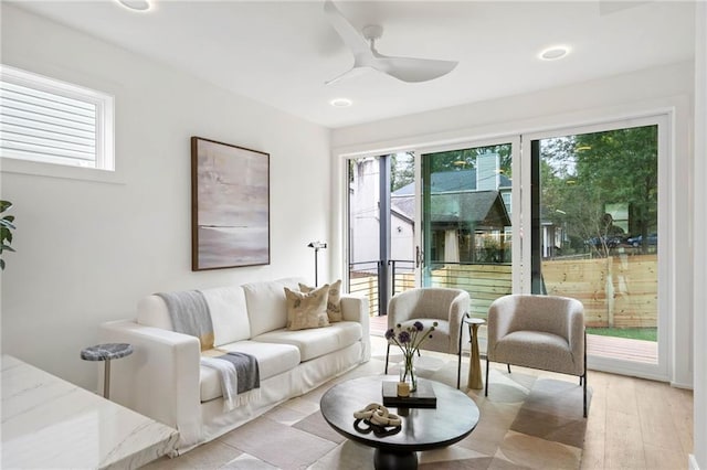 living room with ceiling fan and light hardwood / wood-style flooring