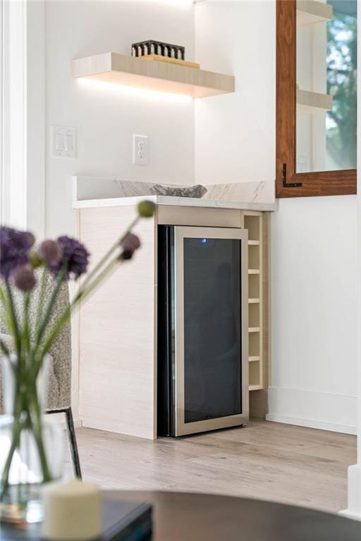 room details with beverage cooler and hardwood / wood-style floors