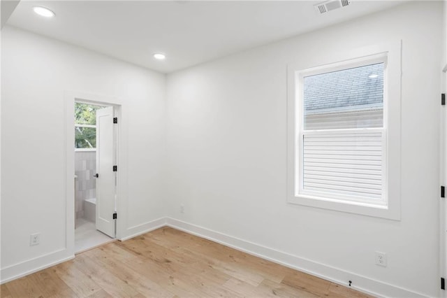 unfurnished room with light wood-type flooring