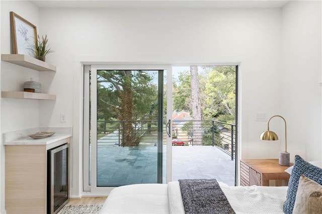 doorway to outside featuring light hardwood / wood-style floors and wine cooler