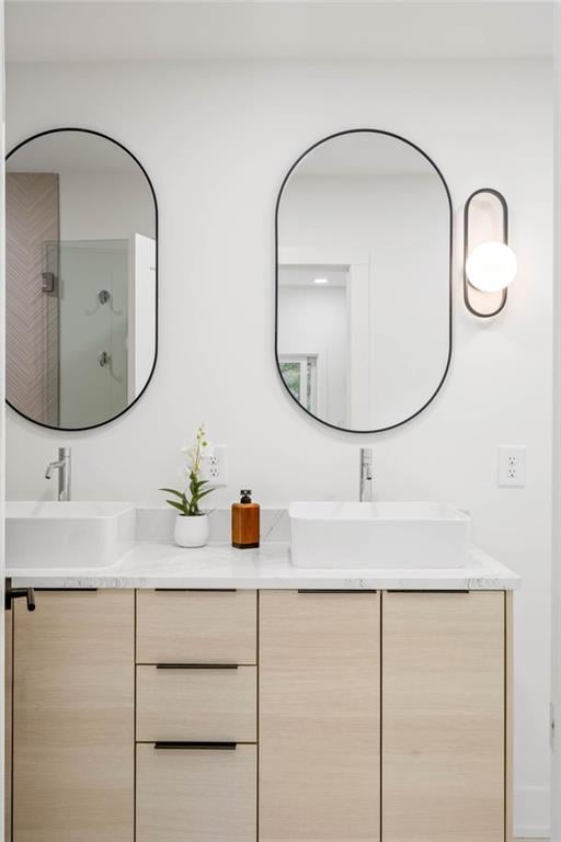 bathroom with a shower with door and vanity