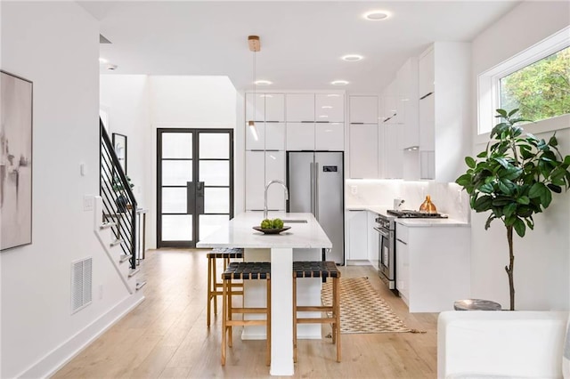 dining room featuring sink and light wood-type flooring