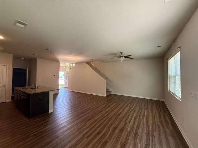 6474 Grey Fox Way, Riverdale, GA 30296 - unfurnished living room with a sink, dark wood-type flooring, a chandelier, stairs, and baseboards