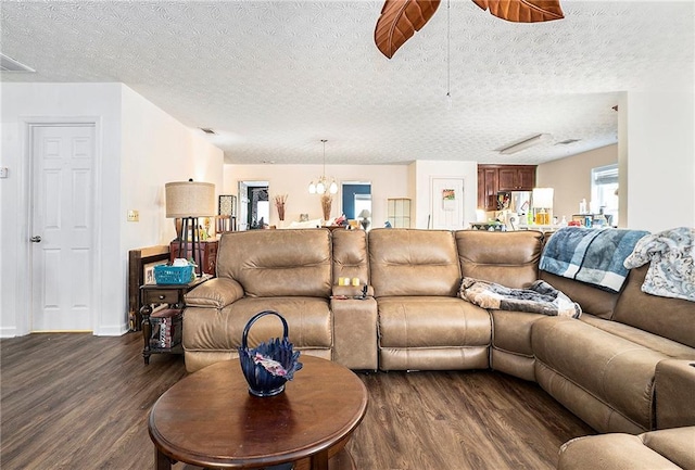 living room with visible vents, dark wood finished floors, a textured ceiling, and baseboards