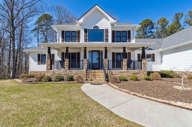 view of front of property featuring stone siding, a porch, and a front lawn