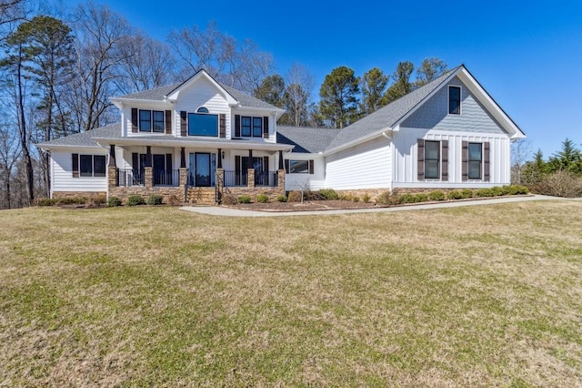 view of front of home with covered porch and a front yard