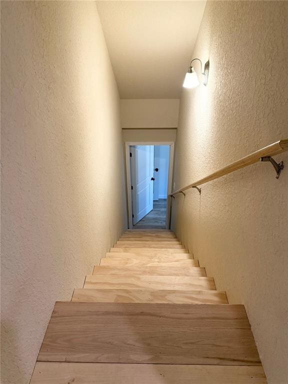 stairs featuring a textured wall