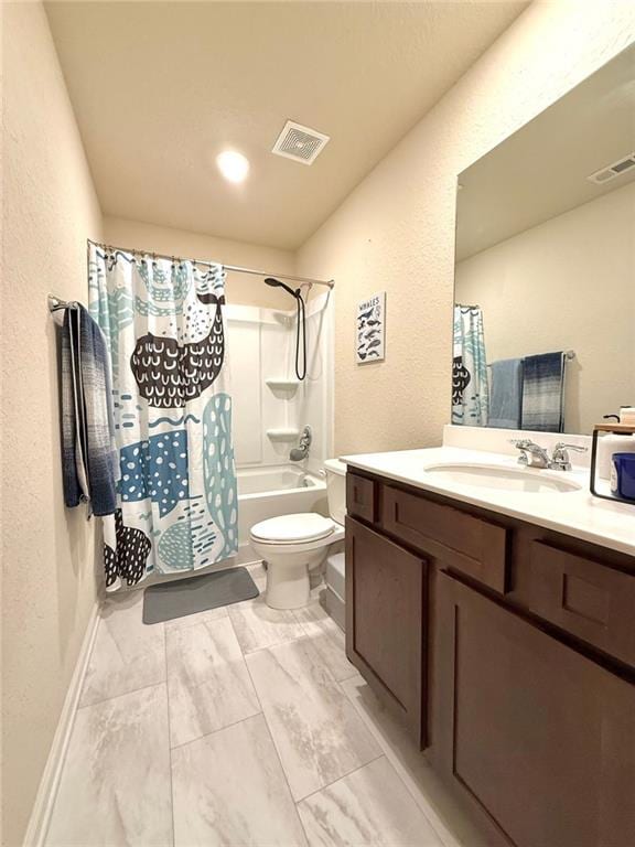 bathroom with a textured wall, vanity, visible vents, and toilet