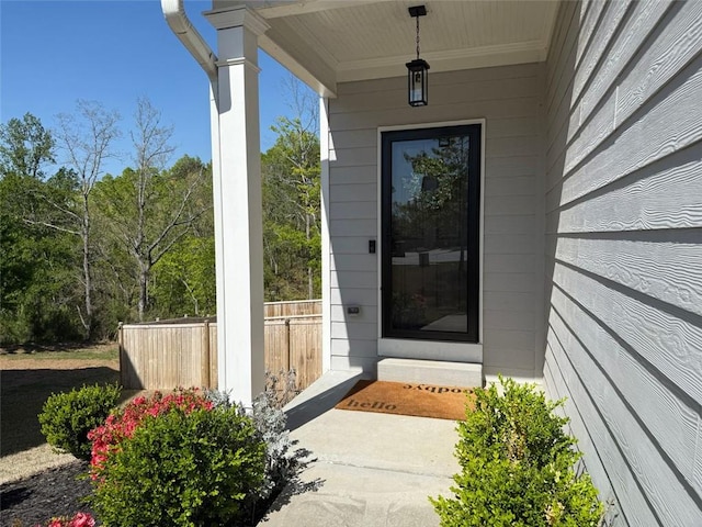 doorway to property featuring fence