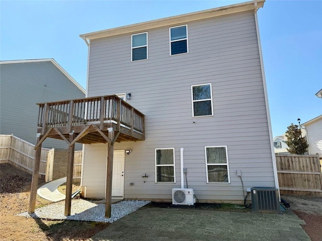 back of house featuring ac unit, fence, a deck, and central air condition unit