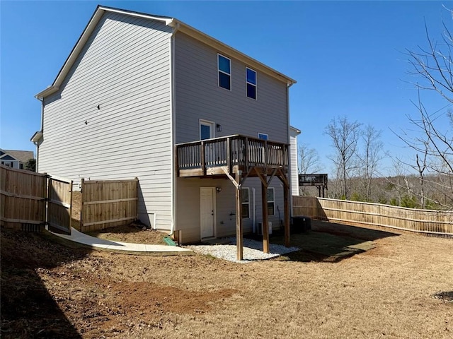 back of house featuring a fenced backyard and a wooden deck