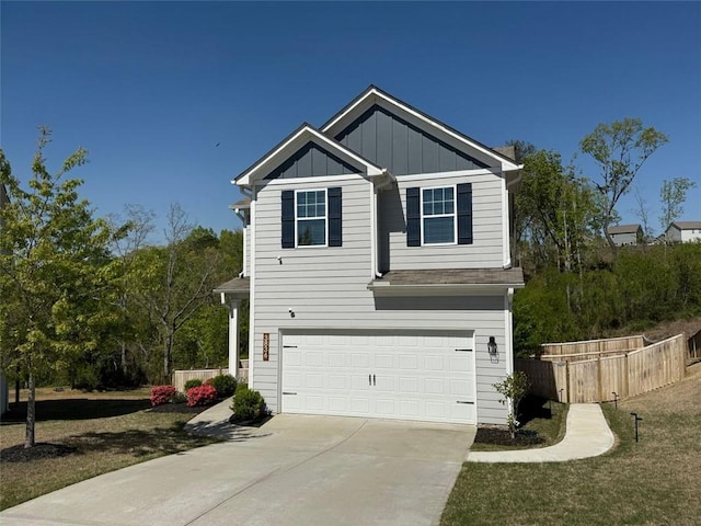view of front of house with an attached garage, board and batten siding, concrete driveway, and fence