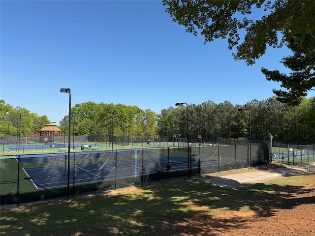 view of sport court featuring fence