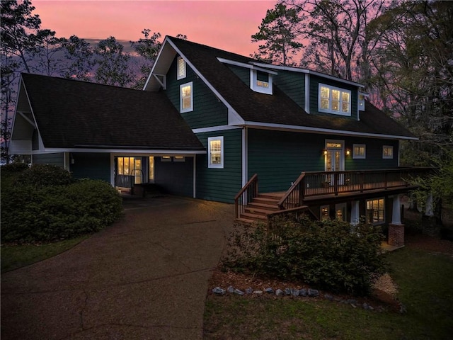 view of front of house featuring driveway and a shingled roof