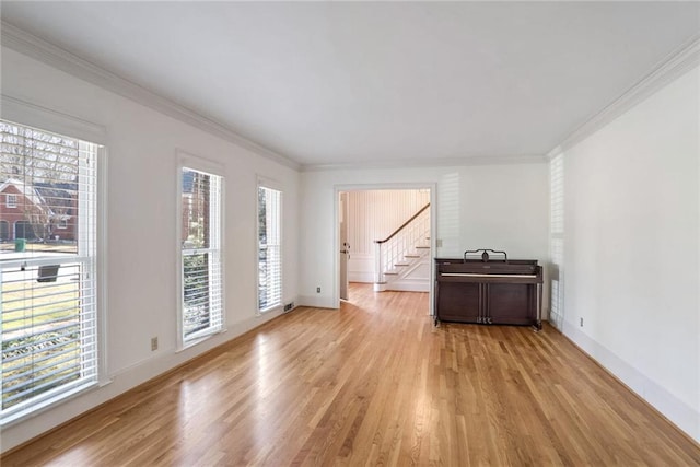 spare room with crown molding and light hardwood / wood-style floors