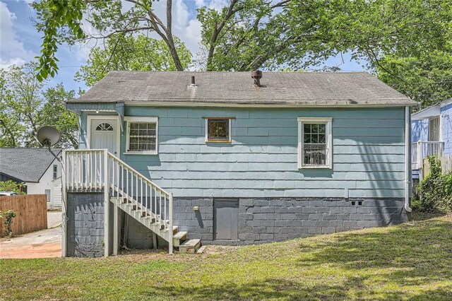 1002 Ira St SW, Atlanta, GA 30310 - back of property with a lawn, roof with shingles, and fence