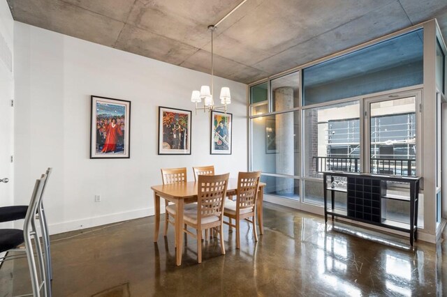 845 Spring St Unit 125, Atlanta, GA 30308 - dining room featuring finished concrete floors, a chandelier, and baseboards