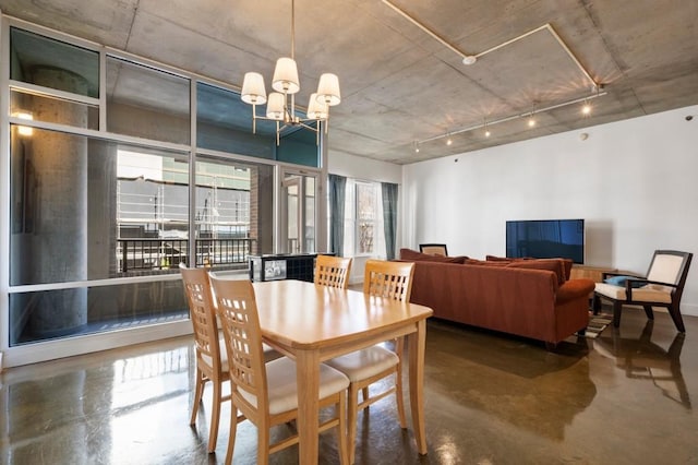 845 Spring St Unit 125, Atlanta, GA 30308 - dining space with finished concrete flooring, a chandelier, and rail lighting