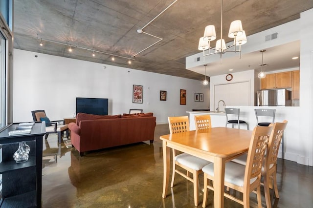 845 Spring St Unit 125, Atlanta, GA 30308 - dining room with finished concrete flooring and a chandelier