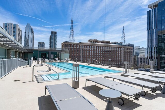 845 Spring St Unit 125, Atlanta, GA 30308 - community pool with a view of skyline, a patio, and fence