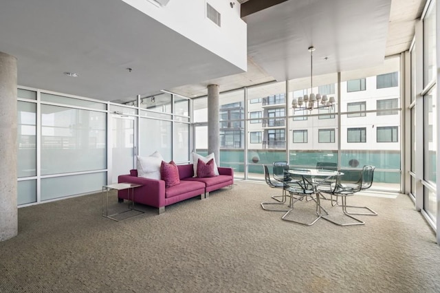 845 Spring St Unit 125, Atlanta, GA 30308 - sunroom featuring carpet flooring, a wall of windows, and a chandelier
