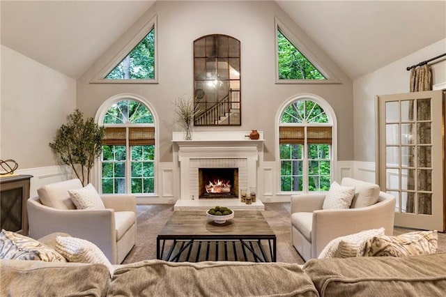 3275 Lord N Lady Ln, Alpharetta, GA 30022 - living room featuring high vaulted ceiling, wainscoting, a decorative wall, and a fireplace