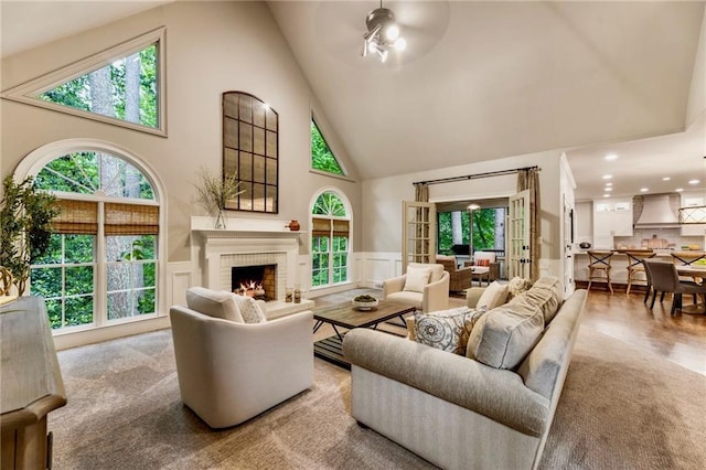 3275 Lord N Lady Ln, Alpharetta, GA 30022 - living room with high vaulted ceiling, wainscoting, a fireplace, ceiling fan, and a decorative wall