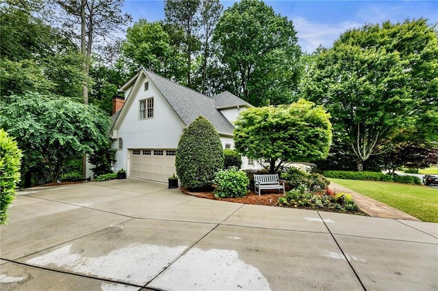 3275 Lord N Lady Ln, Alpharetta, GA 30022 - view of front facade featuring a shingled roof, driveway, stucco siding, view of scattered trees, and an attached garage