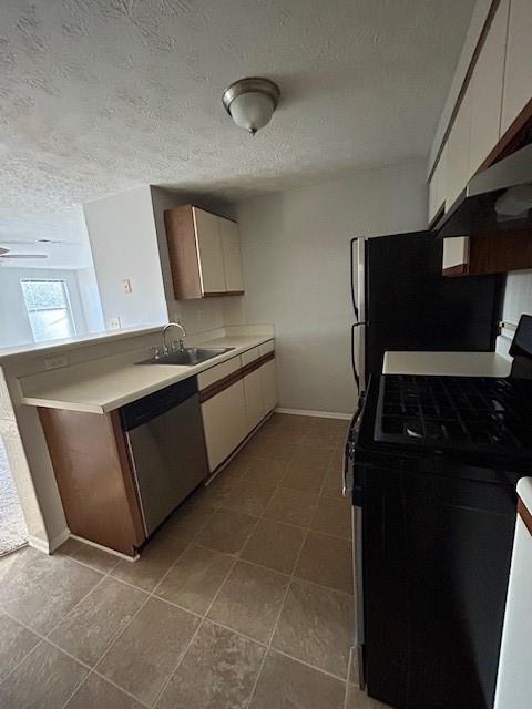 kitchen featuring white cabinetry, black gas range oven, sink, dishwasher, and a textured ceiling