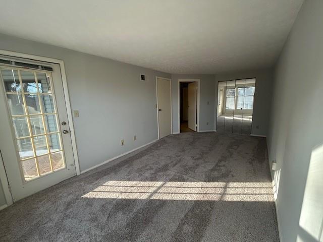 unfurnished living room featuring carpet floors