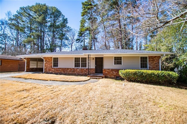 ranch-style home featuring brick siding, crawl space, and a chimney