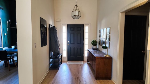 entrance foyer with baseboards and light wood-type flooring