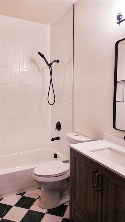 bathroom featuring tub / shower combination, toilet, and vanity