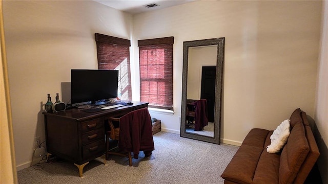 office space featuring visible vents, light colored carpet, and baseboards