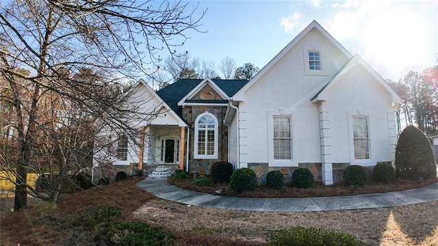 view of front facade with stone siding and stucco siding