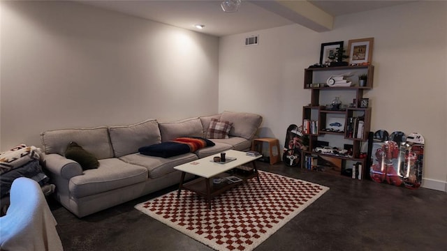 living room featuring beam ceiling, visible vents, and concrete flooring