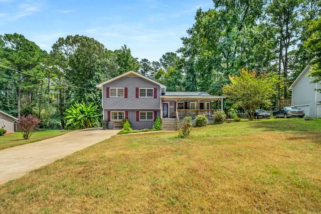 tri-level home featuring a front yard, covered porch, and driveway