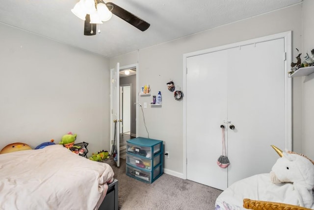 bedroom with a closet, light carpet, and ceiling fan