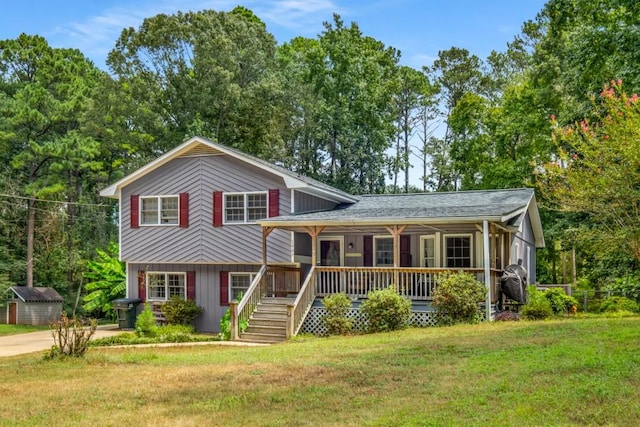 tri-level home with covered porch and a front lawn