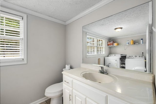 bathroom with vanity, a textured ceiling, crown molding, toilet, and washing machine and dryer