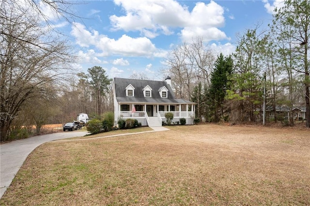 cape cod house featuring driveway, a front lawn, and a porch